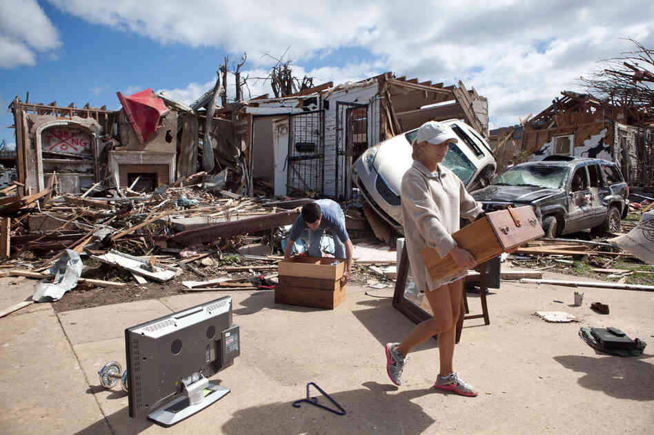 Kelly Giddens (right) helps University of Alabama law student Daniel Hinton remove belongings from his destroyed home in the Cedar Crest neighborhood of Tuscaloosa. 