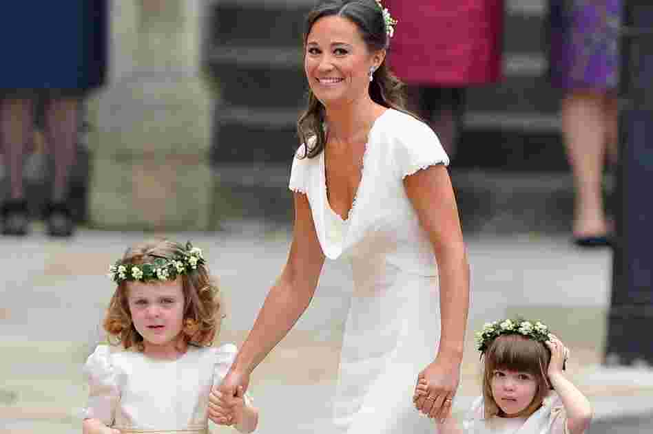 Sister of the bride and maid of honor Pippa Middleton escorts the younger bridesmaids to Westminster Abbey. 
