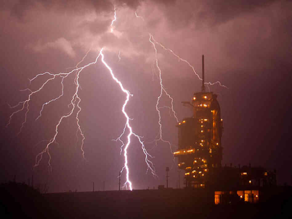 The space shuttle Endeavour is seen on launch pad 39a as a storm passes by prior to the rollback of the Rotating Service Structure (RSS), Thursday, April 28, 2011, at Kennedy Space Center in Cape Canaveral, Fla.
