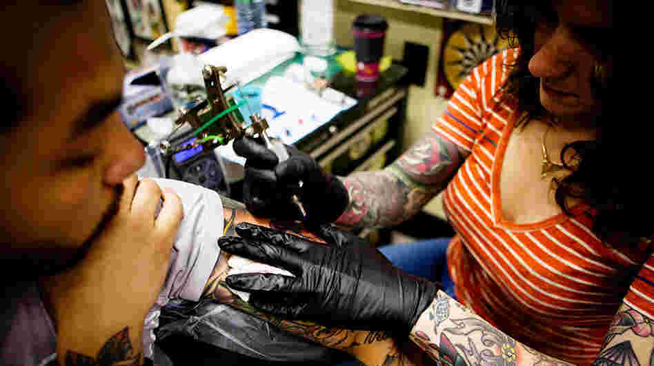 Nikki Lugo tattoos a client at Tattoo Paradise in Washington, D.C., in April. The salon's artists use mostly organic, vegetable-based inks because they feel they are a safer option.