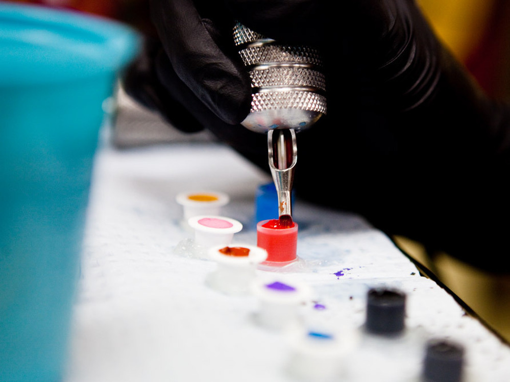A tattoo artist prepares inks before working on a client. The FDA says it wants to learn more about what goes into tattoo inks.