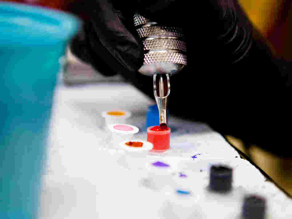 A tattoo artist prepares inks before working on a client. The FDA says it wants to learn more about what goes into tattoo inks.