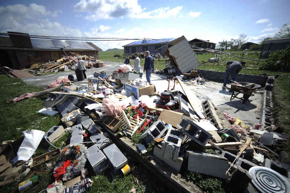 Residents clean up storm damage in Bethel, Va., on Friday. 