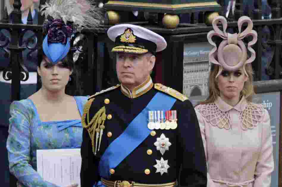 Britain's Prince Andrew (center) and his daughters,  Princess Eugenie (left) and  Princess Beatrice, leave Westminster Abbey after the royal wedding. 
