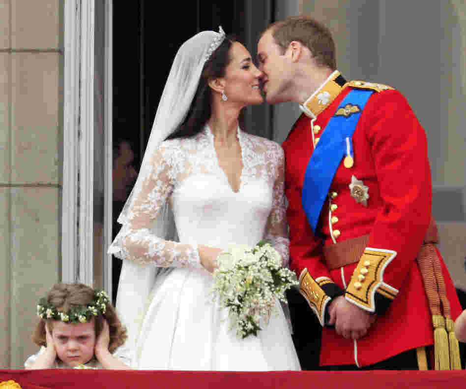 While millions of onlookers enjoyed the newlyweds' kiss at Buckingham Palace, a certain someone (left) seemed to be not pleased. (AP Photo/Matt Dunham)