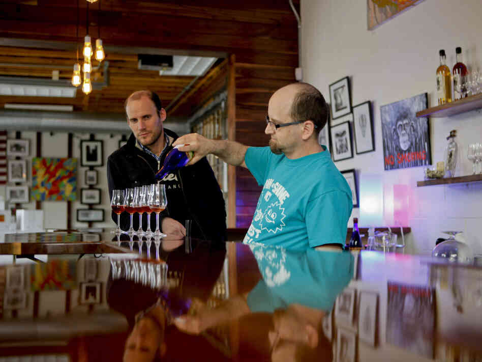 Woody  Drake, mead master at Brothers Drake, pours samples as  general manager Oren Benary (left) observes. It's a common misconception that mead is an exclusively sweet drink. "Mead goes everywhere from dry to sweet and everything in between," Drake says.