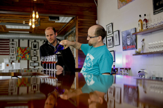 Woody  Drake, mead master at Brothers Drake, pours samples as  general manager Oren Benary (left) observes. It's a common misconception that mead is an exclusively sweet drink. "Mead goes everywhere from dry to sweet and everything in between," Drake says.