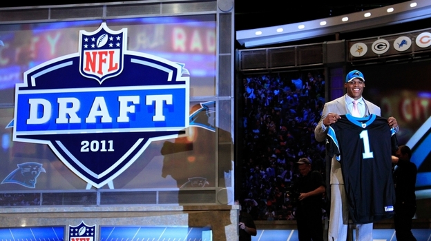Cam Newton, No. 1 overall, was selected by the Carolina Panthers. He holds up a jersey on stage after he was picked during the 2011 NFL Draft at Radio City Music Hall Thursday night in New York City.