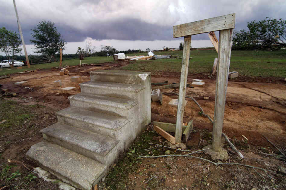 Concrete steps lead to the footprint of a mobile home that was ripped away by a tornado in Preston, Miss. 