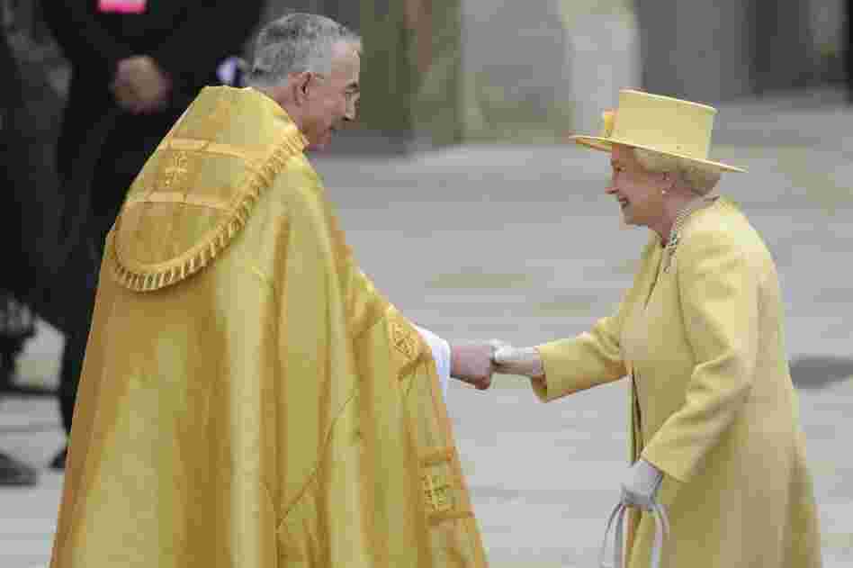Britain's Queen Elizabeth II shakes hands with the Dean of Westminster Abbey as she arrives. 