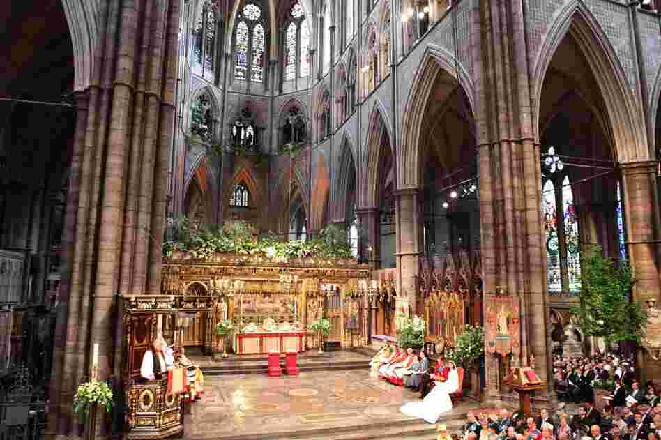 The Rev. Richard, Lord Bishop of London, reads from the pulpit, watched by Prince William and Kate Middleton. 