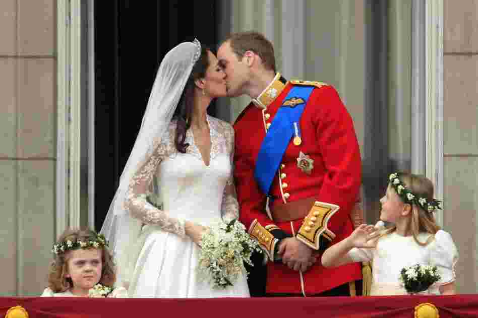 Prince William and Kate, Duchess of Cambridge, kiss on the balcony of Buckingham Palace after the royal wedding in London on Friday. 