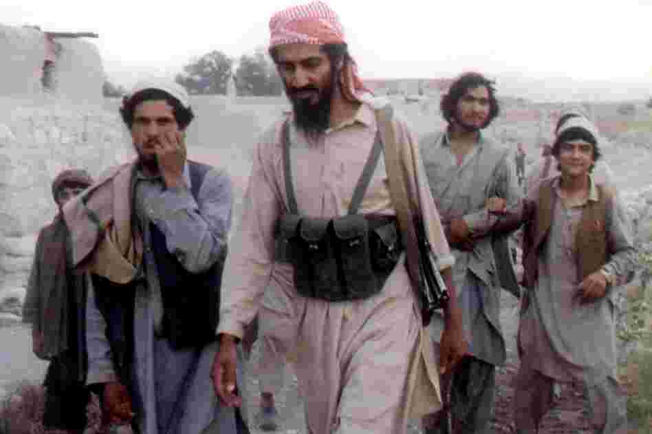Bin Laden (center) walks with Afghanis in Jalalabad, Afghanistan, in 1989. The news of his death sent the world into celebration and protest. 