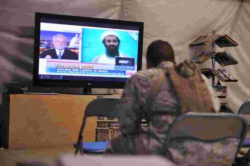 A U.S. Marine watches the news of bin Laden's death at Camp Dwyer in Helmand province, Afghanistan. 
