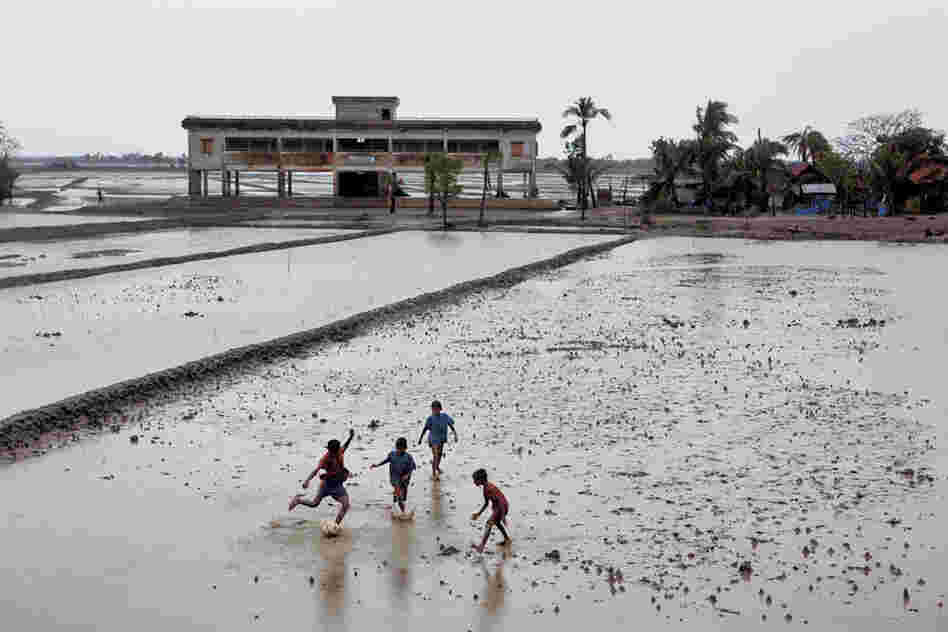 Children play on in Jaliakhali, a village devastated by Cyclone Aila in 2009. That storm sent residents racing for one of thousands of recently built cyclone shelters (above), many of which double as community centers.