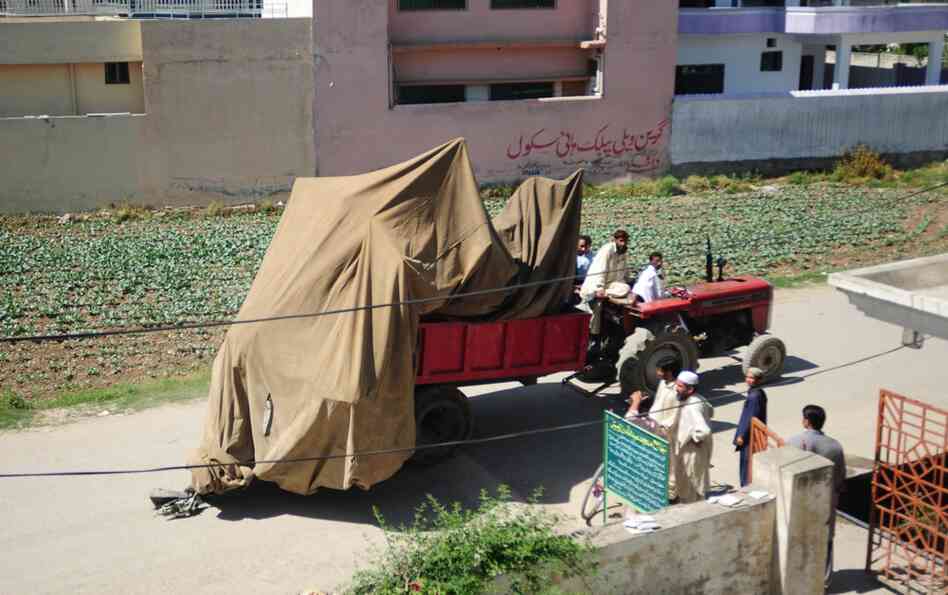 Pakistani army soldiers move a destroyed helicopter from bin Laden's compound in Abbottabad. 