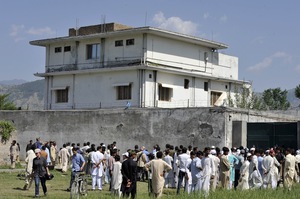 Pakistani media and local residents gather outside the compound. Revelations that bin Laden had been hiding here, possibly for years, have embarrassed Pakistan's military and intelligence establishment.
