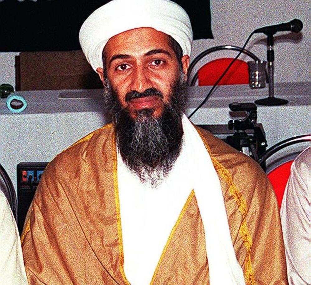 An undated recent picture shows Osama Bin Laden attending a meeting with a Kalashnikov on his lap in an undisclosed place inside Afghanistan