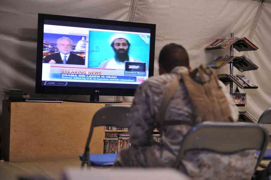 A U.S. Marine watches the news of bin Laden's death at Camp Dwyer in Helmand province, Afghanistan. 