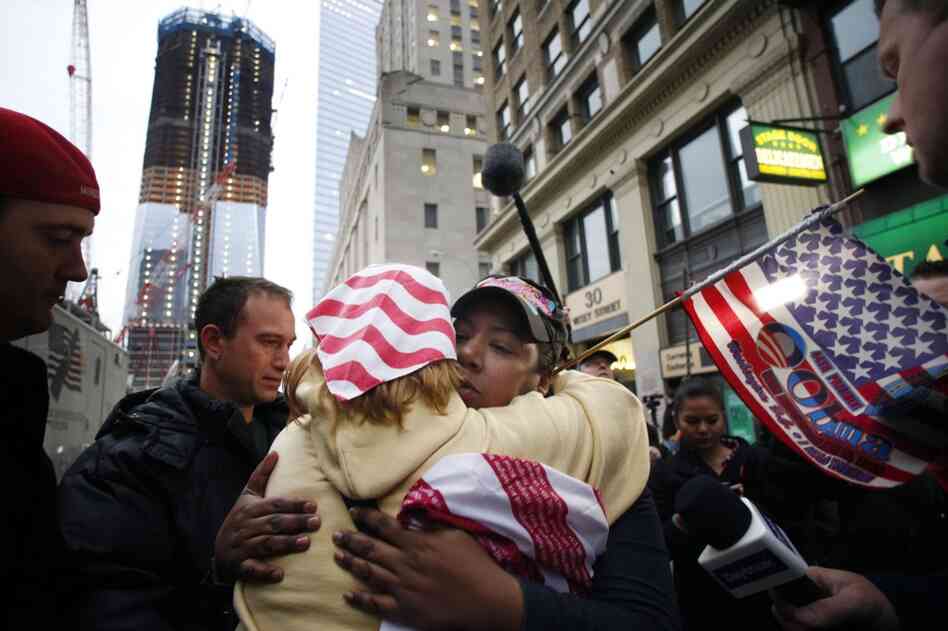Dionne Layne, facing camera, hugs Mary Power at ground zero in New York on Monday as they react to the news. 