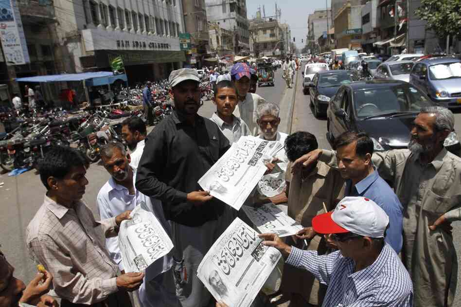 Men in Karachi, Pakistan, buy newspapers reporting the killing of bin Laden. 