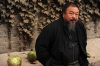 Ai Weiwei sits in the courtyard of his home in Beijing while under house arrest Nov. 7. Ai is one of China's most famous artists and social critics.