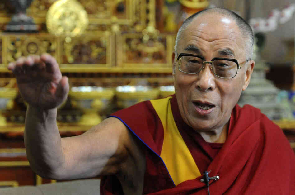 Tibetan Spiritual leader The Dalai Lama gestures as he talks to journalists in Dharamshala on March 17, 2011.