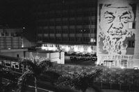 Flash graffiti of Ai Weiwei projected for a split second onto the Chinese People's Liberation Army barracks in Hong Kong. The PLA says this is a breach of the law.
