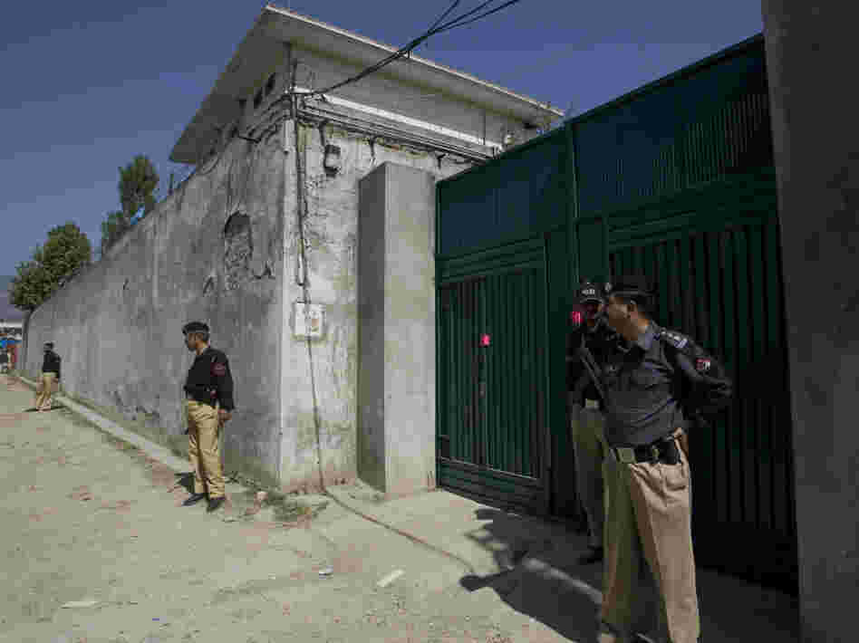 Pakistani police guard the gate of the compound where Osama bin Laden was killed by U.S. forces.