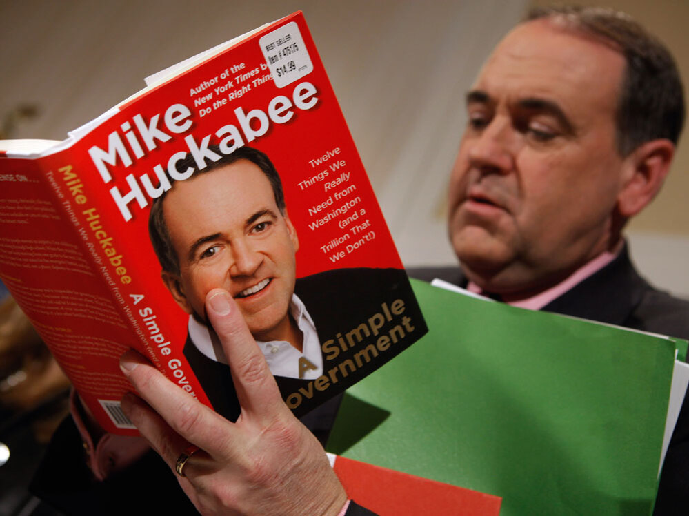 Huckabee signs a copy of his new book, A Simple Government: Twelve Things We Really Need from Washington (and a Trillion that We Don't!), at the National Press Club, February 2011 in Washington.