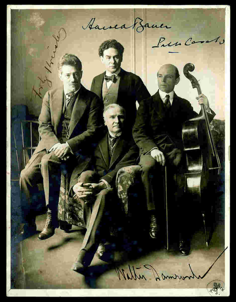 1904: A photo commemorating cellist Pablo Casals' first appearance at Carnegie Hall. Alongside violinist Fritz Kreisler and pianist Harold Bauer, he played in a New York Symphony Society performance of Beethoven's Triple Concerto led by Walter Damrosch. 