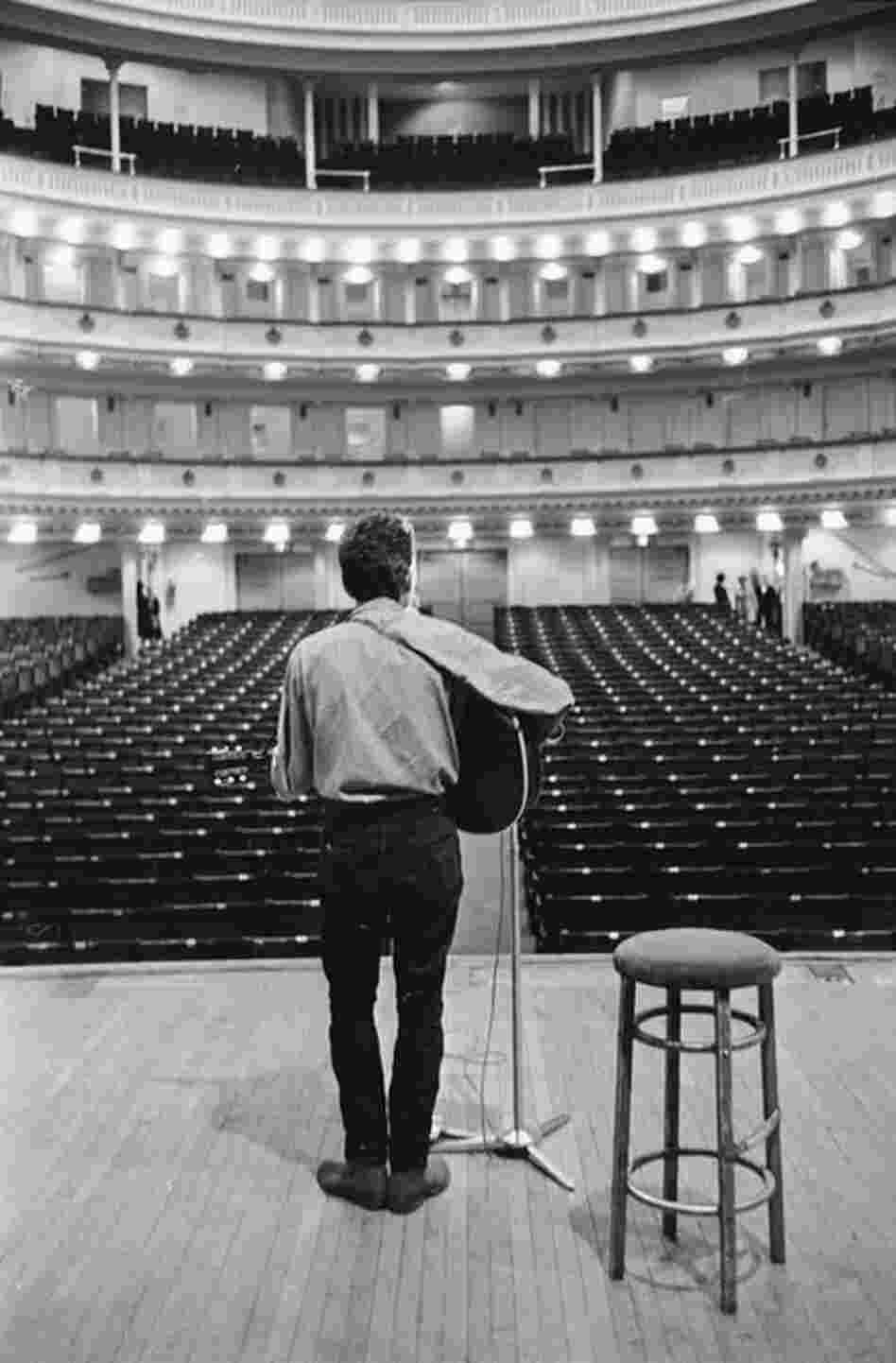 1963: Bob Dylan faces an empty house before his first concert as a Carnegie Hall headliner in October of that year. His set list that night included "The Times They Are A-Changin" and "A Hard Rain's A-Gonna Fall." 