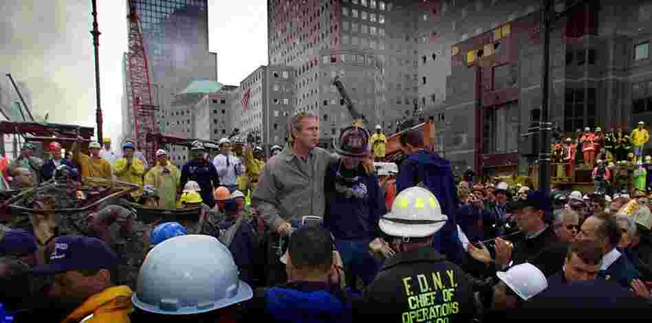 President Bush, surrounded by firefighters, tours the devastation at the center on Sept. 14, 2001. 