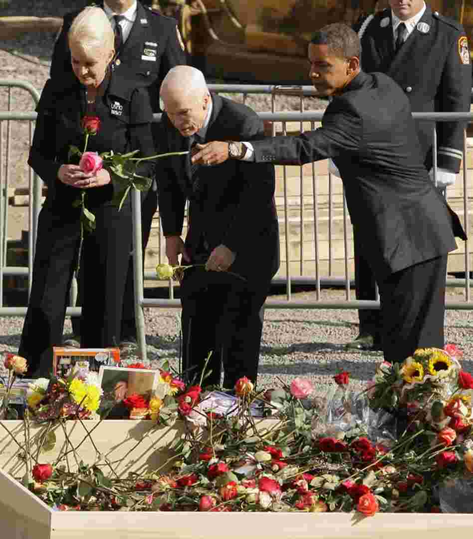 Presidential candidates John McCain, with wife Cindy McCain, and Barack Obama place roses into the reflecting pool at ground zero on Sept. 11, 2008, the seventh anniversary of the attacks on the World Trade Center.