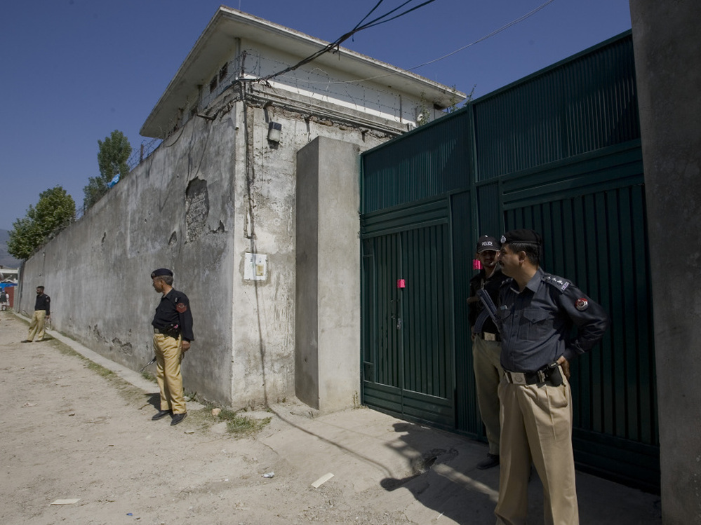 Pakistani police guard the gate of the compound where Osama bin Laden was killed by U.S. forces.