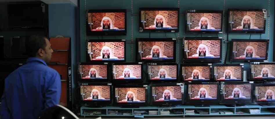 A salesperson in Mumbai, India, watches TV reports on the killing of Osama bin Laden.