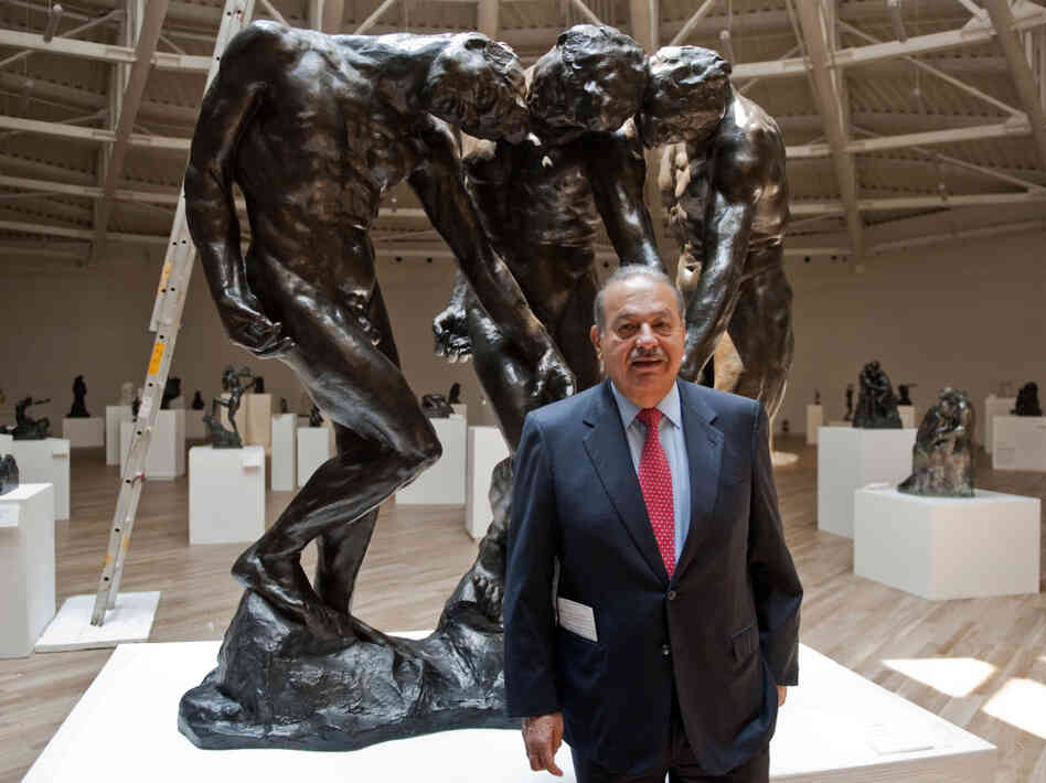 Carlos Slim invested more than $800 million in the Soumaya Museum, the second museum opened by the telecommunications mogul. Here, he stands with Auguste Rodin's The Three Shades on March 28, the eve of the opening.