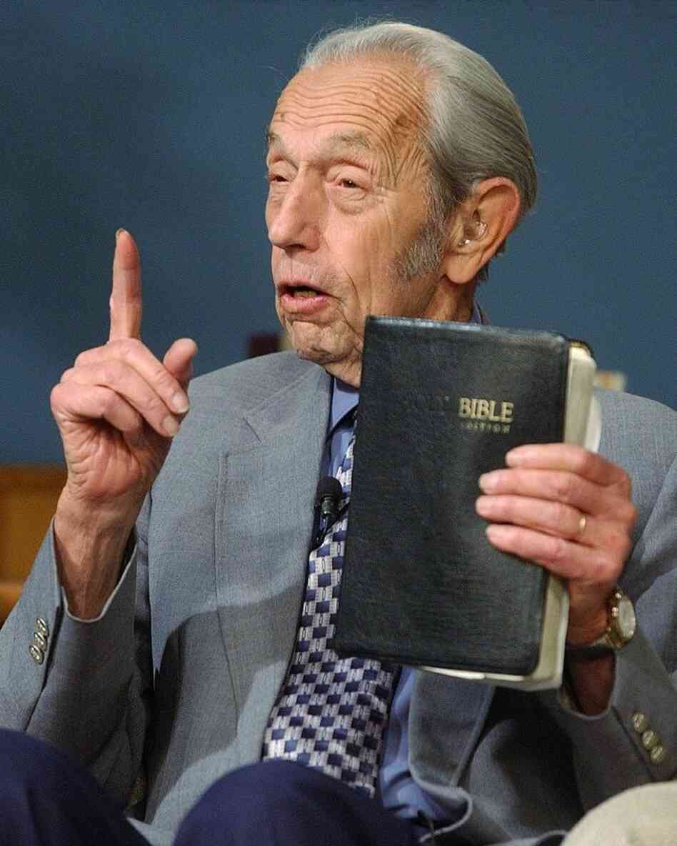 Harold Camping speaks, holding a Bible, during his live television broadcast in 2002.