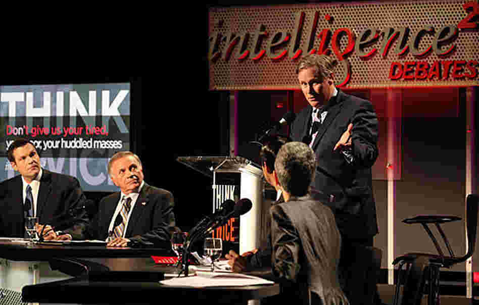 Moderator John Donvan addresses the four experts taking on the motion "Don't Give Us Your Tired, Your Poor, Your Huddled Masses" in an Oxford-style debate May 3 at New York University's Skirball Center for the Performing Arts. Seated are (from left) Kris Kobach, Tom Tancredo, Julian Castro and Tamar Jacoby.