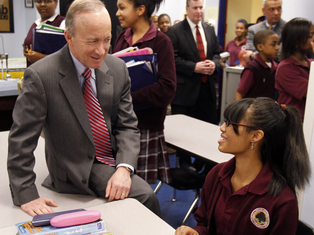 Indiana Gov. Mitch Daniels talks with student Cree DeDeaux, 14, during a tour of an Indianapolis school. Indiana recently expanded its school voucher program, making  it one of the most extensive in the nation.