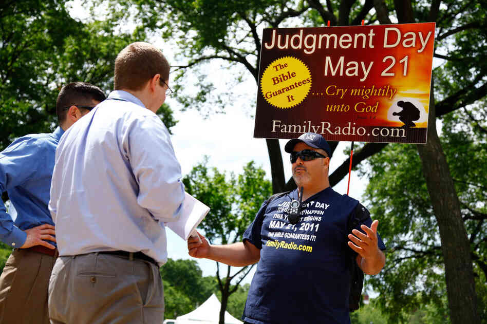 David Liquori (right) talks to two men on National Mall in Washington, D.C., on Friday. The Long Islander has been speaking about Judgment Day for 23 years. His passion for the message resulted in the end of his marriage because his wife had different views. His 12-year-old son is skeptical of his father's views, and Liquori worries about him. He isn't sure how he plans to spend May 21, but he ...