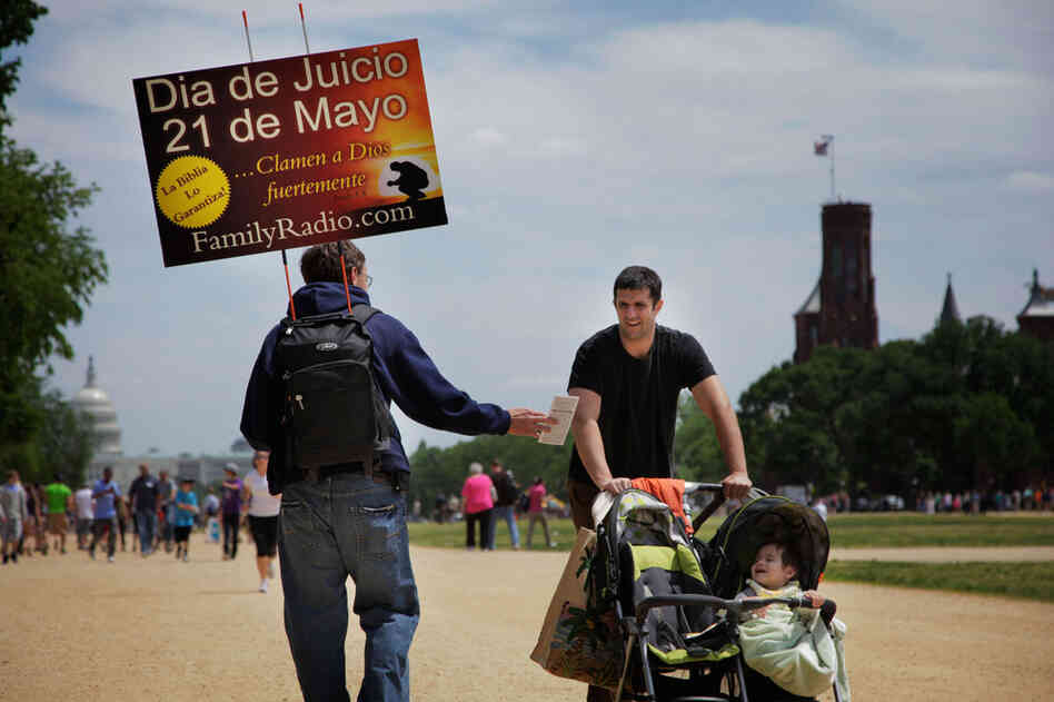 Robert Carson of Middletown, Md., hands out tracts to a passerby along the National Mall. The nuclear engineer and his wife, Abby, came out to meet the traveling caravan for its stop in Washington. The couple have three teenagers who do not believe in the May 21 prediction, but they are hopeful that the teens will come around within the next two weeks. 