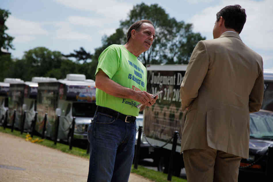 Fred Store engages a passerby in conversation as he passes out tracts on the Mall. The retired electrician has been listening to Family Radio since 1983, and in September he joined the caravan project, which travels throughout the country to warn people of Judgment Day. There are five trucks per caravan and five active caravans. 
