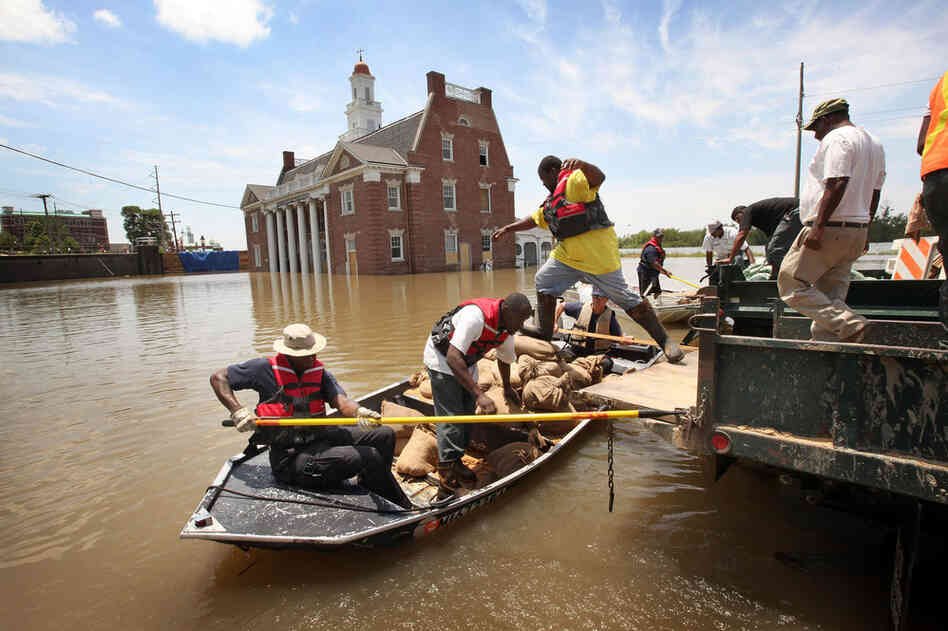 MAY 11: City workers load sandbags for re-enforcing a levee gate onto a boat in Vicksburg. Historic Vicksburg, the site of a pivotal Civil War battle, has been one of the hardest-hit cities.  