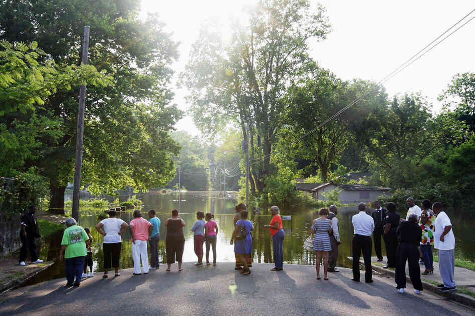 MAY 8: Residents gather at the edge of the floodwaters in the West Junction neighborhood of Memphis. 