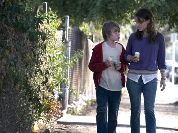 Hesher enourages T.J. (Devin Brochu, left) to chase after — some might say stalk — a local supermarket cashier (Natalie Portman).