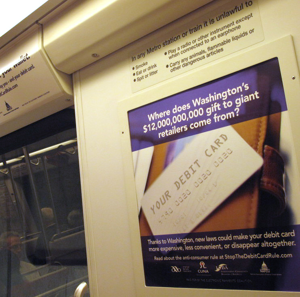 Ads like these — from the Electronic Payments Coalition — appear in about 100 rail cars within the Washington, D.C., Metrorail system.
