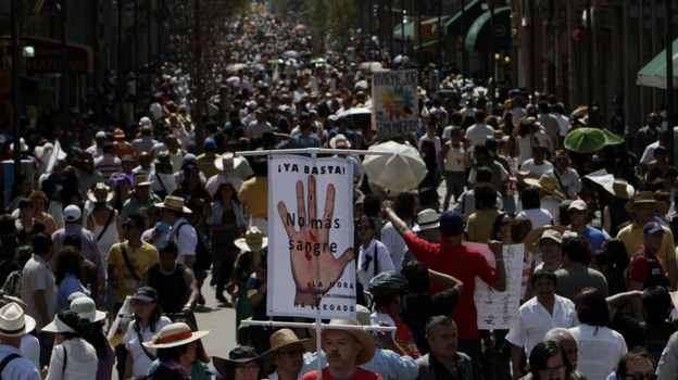 A demonstrator holds a sign reading 'Stop! no more Blood', during a march against gang violence in Mexico City, Sunday, May 8, 2011.