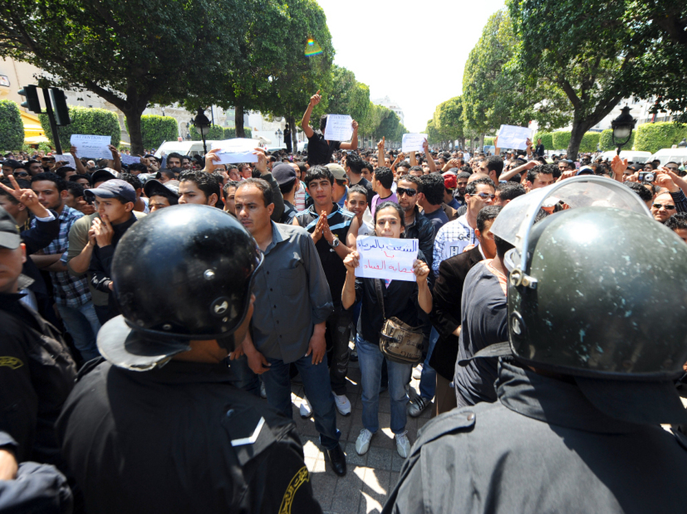 Tunisian riot police face protestors in the center of Tunis on May 6 during a demonstration organized by youths denouncing the transitional government and calling for "a new revolution."