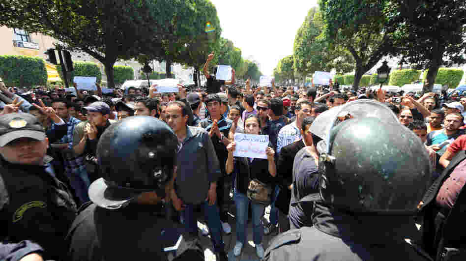 Tunisian riot police face protestors in the center of Tunis on May 6 during a demonstration organized by youths denouncing the transitional government and calling for "a new revolution."